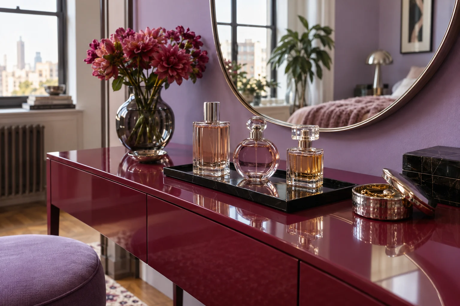 Glass perfume bottles on a raspberry dressing table against a lilac wall in soft morning light